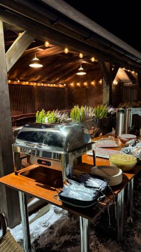a kitchen with a toaster on a table with food at Hotel Wisła Premium in Wisła