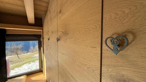 a wooden wall with a heart on it at Lo Chalet Incantato del Maso K in Folgaria