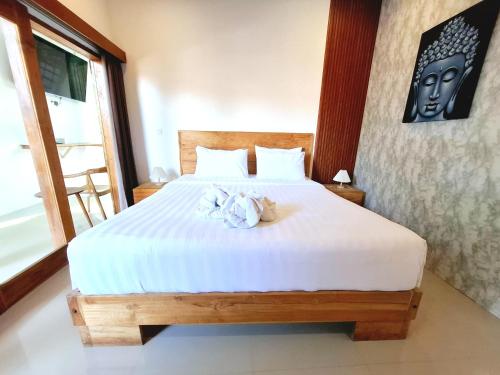a bedroom with a large bed with white sheets at Villa Manayasa in Lovina