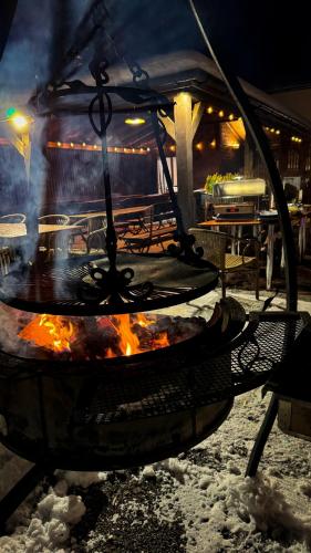 a large grill with a fire in it at night at Hotel Wisła Premium in Wisła