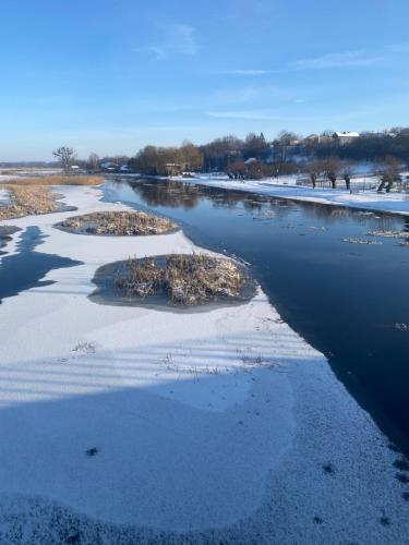 an aerial view of a river with snow at Biebrzańska Przystań 3 in Goniadz