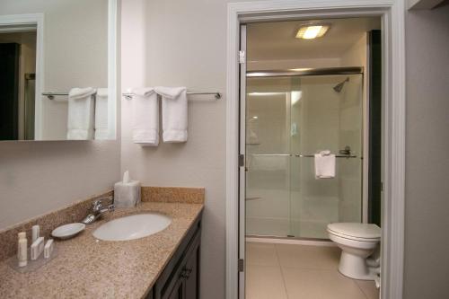 a bathroom with a sink and a toilet and a shower at Residence Inn by Marriott Springdale in Springdale