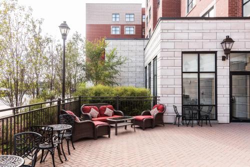 a patio with couches and tables and chairs at Residence Inn by Marriott Ottawa Airport in Ottawa