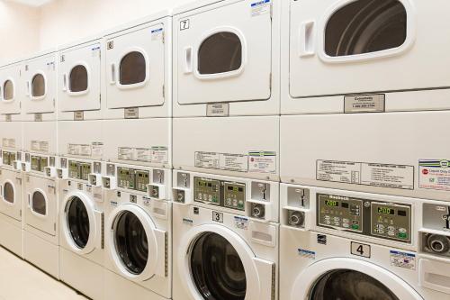 a row of washing machines in a laundromat at Residence Inn by Marriott Ottawa Airport in Ottawa