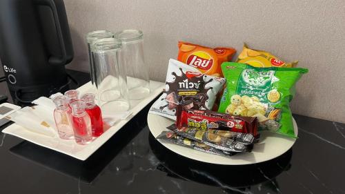 a plate with chips and snacks on a table at Eastern View Resort and Pool Villa in Ban Tao Than