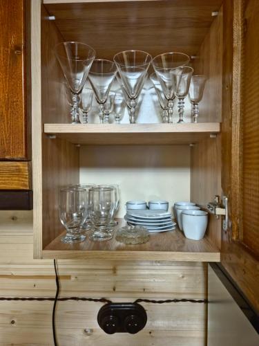 a cupboard with glasses and plates in it at Old Byurakan Cottage in Byurakan