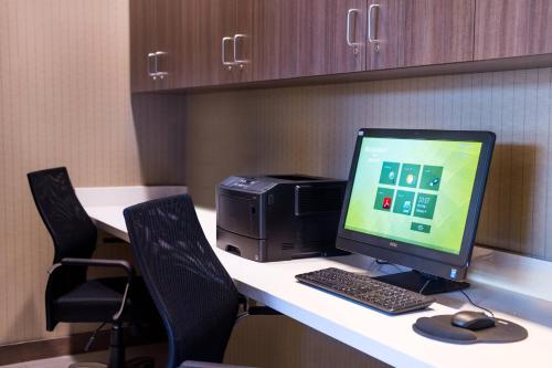 a desk with a computer and a printer on it at Residence Inn by Marriott Seattle University District in Seattle