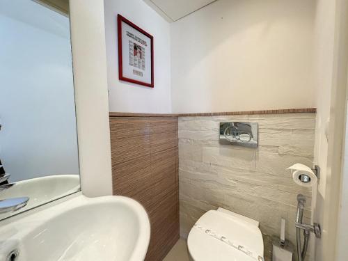 a bathroom with a white toilet and a sink at Modern 2-Bedroom Stunning Sea View on La Croisette in Cannes