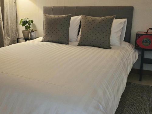 a large white bed with two pillows on it at Hej Hi Home II in Seoul