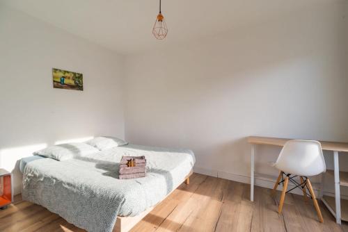 une chambre avec un lit, un bureau et une chaise dans l'établissement Appartement 3 chambres avec terrasse a Saint-Brieuc, à Saint-Brieuc