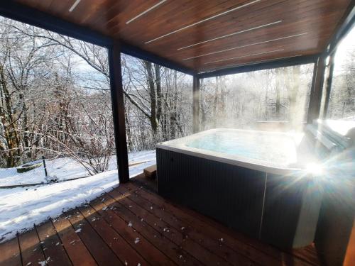 a jacuzzi tub in a room with a window at Penzion U Hráze in Luhačovice