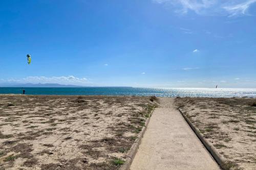 a path on the beach with a kite in the sky at Casa Susy in Oristano
