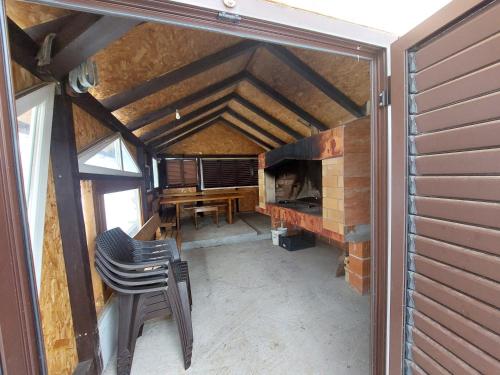 an attic room with a table and a chair at Natura hause in Rakovica