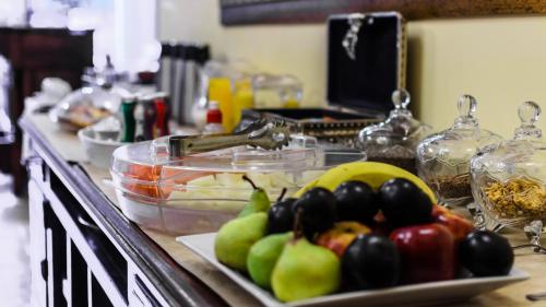a counter with a plate of fruit on a table at La Casona Hotel Boutique in Asuncion