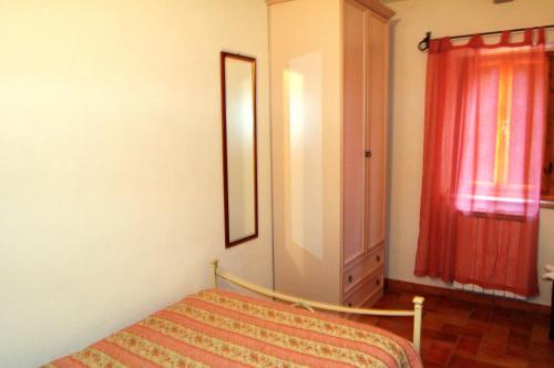 a bedroom with a bed and a dresser and a window at Borgo Nuovo San Martino in Ambra