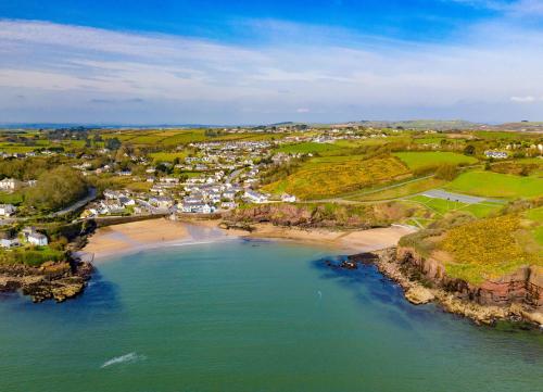 an aerial view of a beach with a town at Seacliff Holiday Homes No 12 by Trident Holiday Homes in Dunmore East
