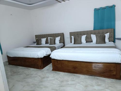 Ένα ή περισσότερα κρεβάτια σε δωμάτιο στο Avinash residency