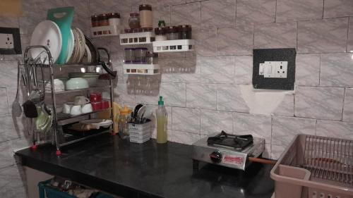 a kitchen with a counter and a counter top with a shelf at Khadim Villa & Travel Planners in Srinagar
