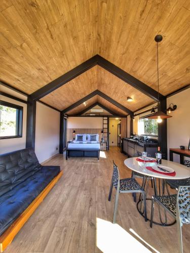 a room with a bed and a table and chairs at Canastra Vibes in São Roque de Minas