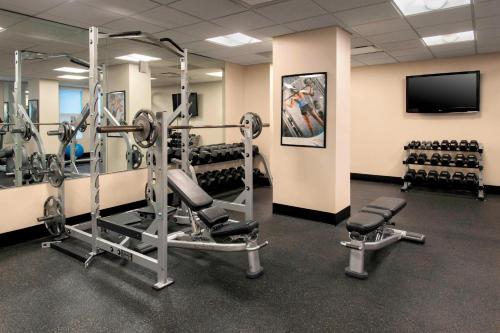 a gym with tread machines and a flat screen tv at Residence Inn by Marriott Alexandria Old Town South at Carlyle in Alexandria