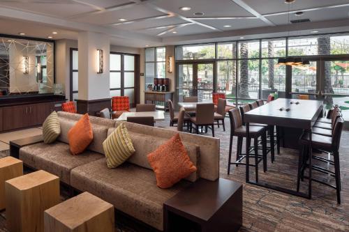 a living room with a couch and tables and chairs at Residence Inn Irvine John Wayne Airport Orange County in Irvine