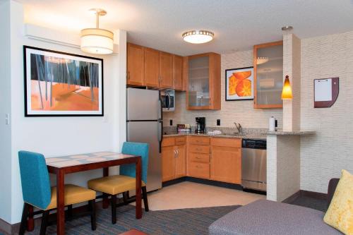 a small kitchen with a table and chairs in a room at Residence Inn Toledo Maumee in Maumee