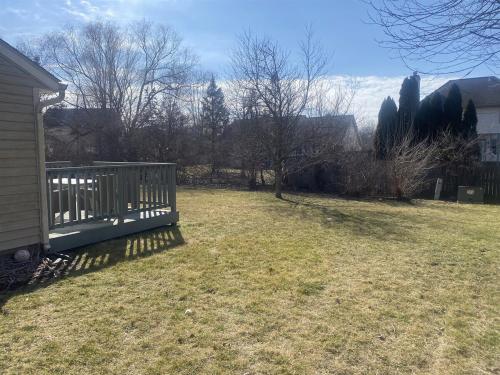 a yard with a wooden fence in the grass at Neighborhood ranch with parks, 3 miles to Purdue in West Lafayette