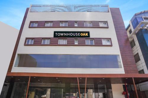 a tall building with a tumulus gym sign on it at Townhouse OAK XOTEL near silk board metro in Bengaluru
