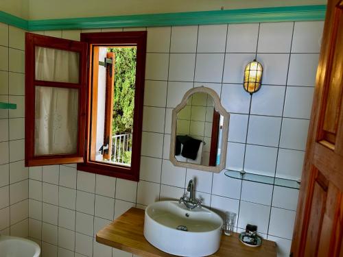 a bathroom with a sink and a mirror at Villa Athena Skiathos in Megali Ammos