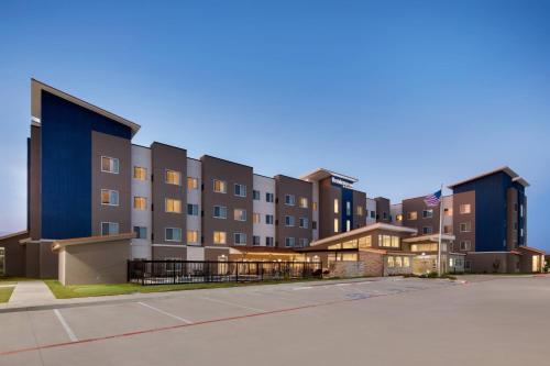 an empty parking lot in front of a building at Residence Inn Waco South in Waco