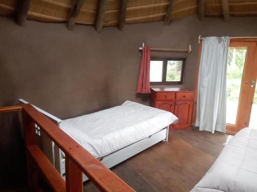 a bedroom with two bunk beds and a window at Tierra Colibrí in Punta Colorada