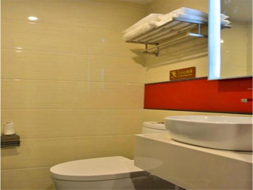 a bathroom with a white toilet and a sink at IU Hotel Beijing West Coach Station Liuliqiao East Metro Station in Beijing