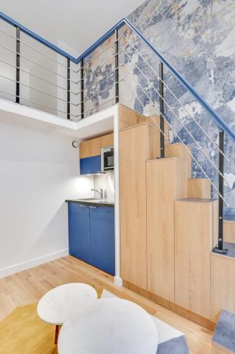 un salon avec un escalier et une cuisine dans l'établissement Flexliving - One bedroom apartment - Bretagne, à Paris