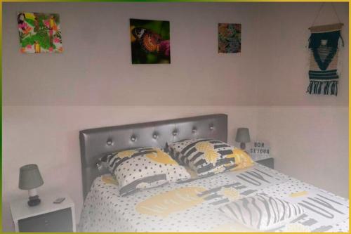 une chambre avec un lit avec des oreillers dessus dans l'établissement Le Lodge Central - Parking - Vue Piscine - By Montauban City, à Montauban