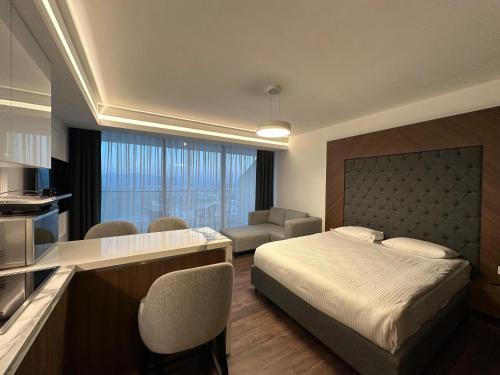 a hotel room with a bed and a kitchen at Grand Sapphire Residence By Aircyp in Iskele