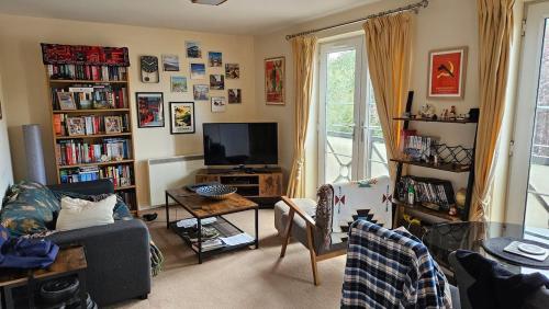 a living room with a couch and a tv at Cosy York Apartment in York