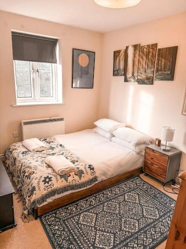 a bedroom with a large bed and a rug at Cosy York Apartment in York