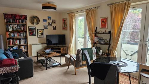 a living room with a couch and a table and a tv at Cosy York Apartment in York