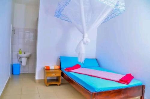 Postel nebo postele na pokoji v ubytování ACP Hotel-Kigogwa