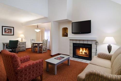 a living room with a couch and a fireplace at Residence Inn Santa Fe in Santa Fe