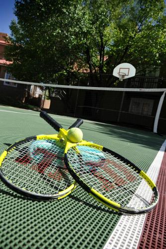 two tennis rackets sitting on a tennis court at Residence Inn Santa Fe in Santa Fe