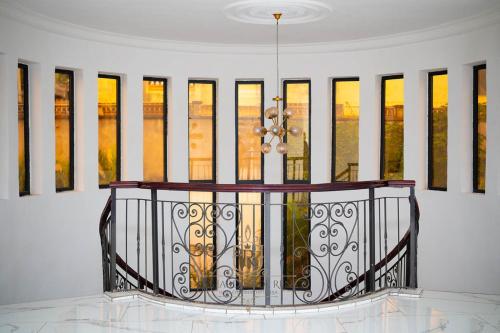 a white room with a balcony with a window at Les Jardins de René Hébergements in Yaoundé
