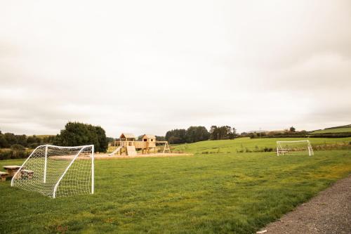 a field with two soccer goals in the grass at Lily in Rhayader