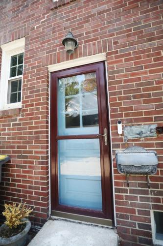 a red brick building with a door with a window at Purdue Bell Tower views, Central WL location, Walk 2 Purdue in West Lafayette