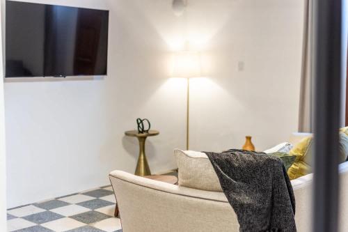 a living room with a chair and a lamp at Casa Las Ruinas by Stay with Bear in San Juan