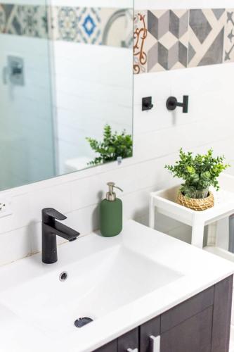 a bathroom with a sink and a mirror at Casa Las Ruinas by Stay with Bear in San Juan