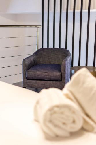 a chair in a room with a chair and a pillow at Casa Las Ruinas by Stay with Bear in San Juan