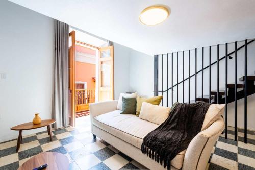 a living room with a couch and a table at Casa Las Ruinas by Stay with Bear in San Juan