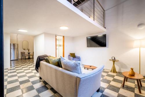 a living room with a couch and a table at Casa Las Ruinas by Stay with Bear in San Juan