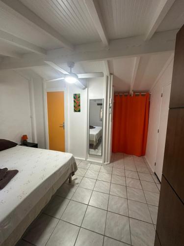 a bedroom with a bed and a room with a bathroom at Gwada Rêves in Sainte-Anne